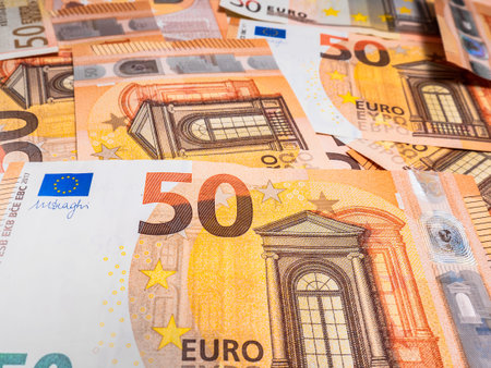 Macro view of fifty euro bills piled up forming an abstract background