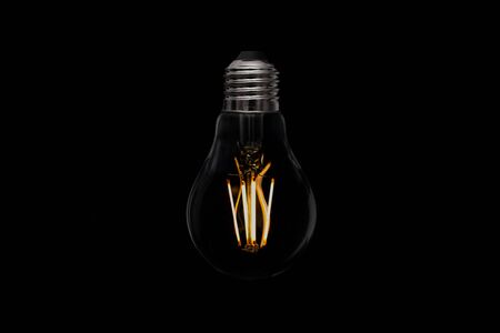 Light bulb on black backgroundの写真素材