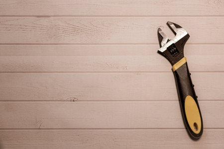 DIY background with an open wrench on a wooden table