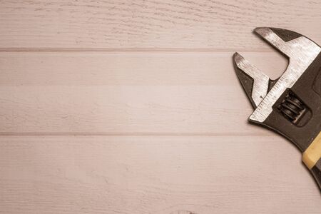 DIY background with an open wrench on a wooden tableの写真素材