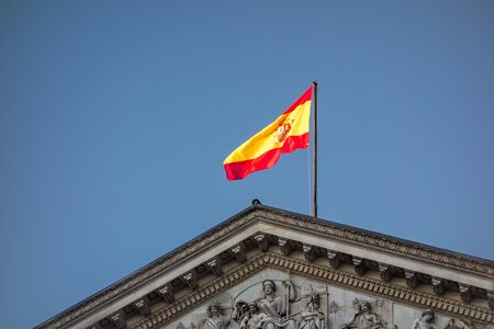 Madrid, Spain; 06/12/2019: Gable of the facade of the congress building of the deputies of Spain, where the representatives elected by the Spanish people work, topped by a Spanish flagの写真素材
