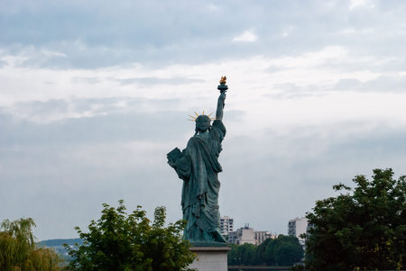 Statue of Liberty in Paris, France seen from behind on a cloudy day