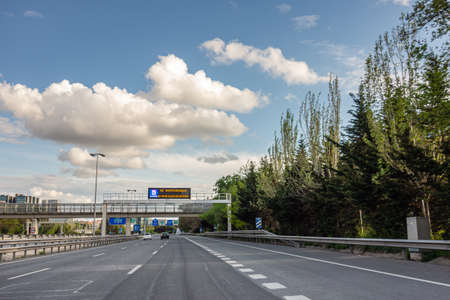 M-30 ring road in Madrid, Spain with less traffic than usual due to the state of alarm decreed by the government due to the Covid-19 pandemic and a bright sign that says: Be responsible I stay at homeのeditorial素材