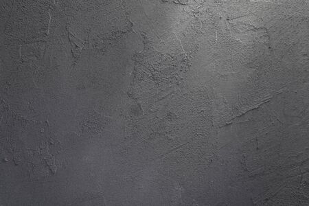 Background image of a gray stone wall with a ray of light passing through itの写真素材