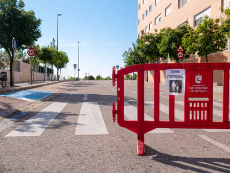 San Sebastian de los Reyes, Madrid, Spain, 05/22/2020: Roads cut for exclusive pedestrian use marked with a fence and a sign with the text "pedestrian zone" during the coronavirus alarm stateのeditorial素材
