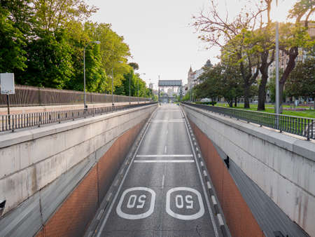 Madrid, Spain, 01/05/2020: O'Donnell street, next to the Retiro Park, completely empty due to the state of alarm due to coronavirus with Puerta de Alcala in the background with a large black ribbonのeditorial素材