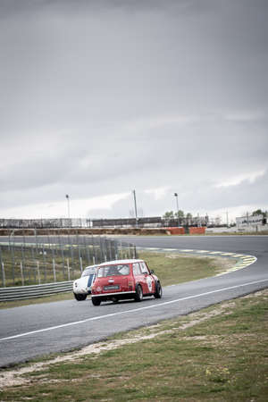 Circuit of Jarama, Madrid, Spain; April 03 2016: Mini Cooper S MK3 overtaking a TVR Griffith in a classic car race at the Jarama circuitのeditorial素材