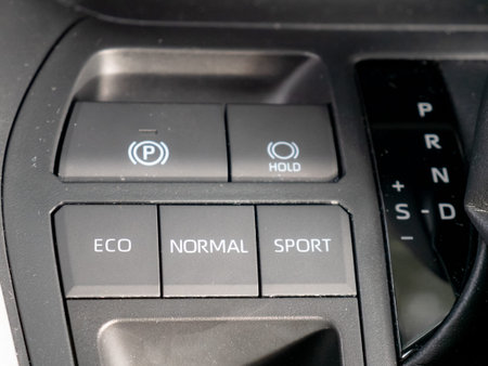 Buttons on the dashboard of a hybrid vehicle indicating the driving modes and the letters of the...