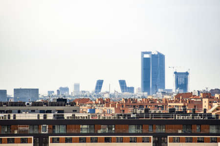 View of the Kio towers and the four Business Area Towers next to Plaza de Castilla on a cloudy day from the city of Madridの写真素材