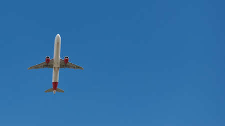 Madrid, Spain; 09-25-2021: Airbus A321 of the Iberia Express airline seen with a low angle just after take off in a blue skyのeditorial素材