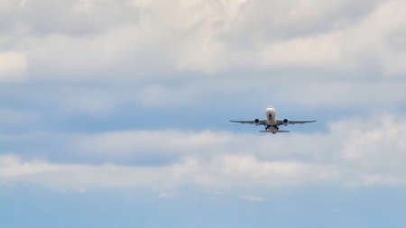 Madrid, Spain; 09-25-2021: Iberia airline Airbus A320 plane folding the landing gear after take off in a blue sky with cloudsのeditorial素材