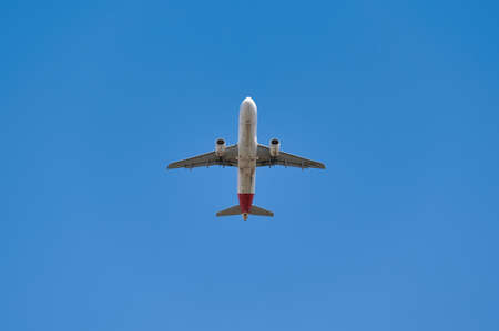 Madrid, Spain; 09-25-2021: Airbus A320 of the Iberia airline seen with a low angle just after take off in a blue skyのeditorial素材