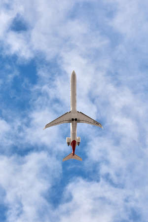 Madrid, Spain; 09-25-2021: Mitsubishi CRJ-1000 model airplane, from Iberia Regional airline, seen with a low angle view shortly after taking off with a nice cloudy sky behindのeditorial素材