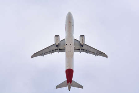 Madrid, Spain; 09-25-2021: Airbus A320 of the Iberia airline seen with a low angle view just after take off in cloudy blue skyのeditorial素材