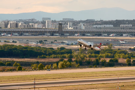 Madrid, Spain; 09-25-2021: Airbus A321 aircraft of the Turkish Airlines airline taking off from Madrid Barajas airport, also seeing the terminal and the control towerのeditorial素材