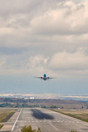 Madrid, Spain; 09-25-2021: Runway with rubber marks from aircraft landings, while a Boeing 737 aircraft of Amazon Air airline takes offのeditorial素材