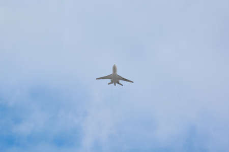 Madrid, Spain; 09-25-2021: Dassault Falcon 2000EX model airplane, seen with a low angle view shortly after taking off with a cloudy sky behindのeditorial素材