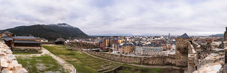Ponferrada, Leon, Spain; 12-12-2021; Panoramic view of the city of Ponferrada from the walls of the medieval castle of the Templars. A cloudy day with fog in El Pajariel and the mountainsのeditorial素材