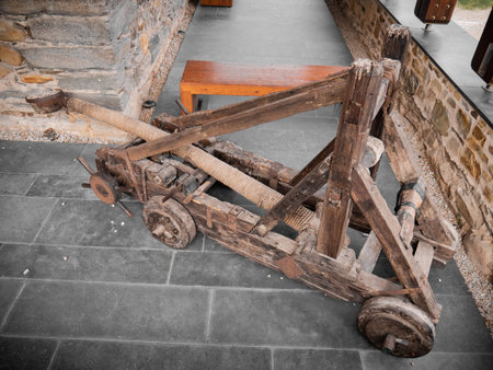 Classic catapult made manually with wood and ropes representing the typical weaponry of the middle ages to defend medieval fortresses and castlesの写真素材