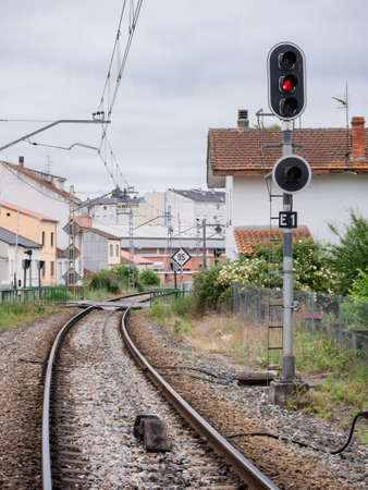 High railway entrance (E1) sign at the Monforte de Lemos station indicating a stop in red on its lamp and the ASFA beacon at the foot of the associated signal located between the rの写真素材