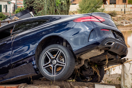 The Alamo, Madrid, Spain; 04-09-2023: Mercedes brand car destroyed on the banks of a river after a strong summer storm after being swept away by the force of the waterのeditorial素材