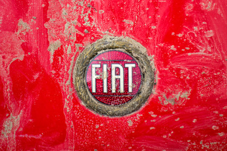 Madrid, Spain; 05-09-2023: Emblem of the Italian brand Fiat (Fabbrica Italiana Automobili Torino) that has been selling cars since 1899 when it was founded in Turin, Italy stained by mudのeditorial素材