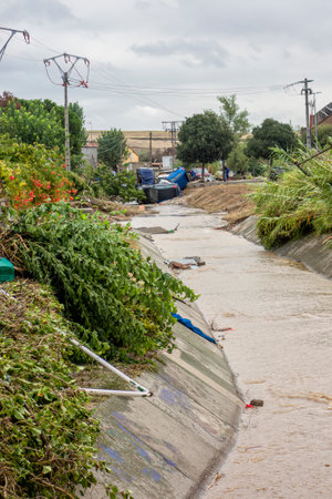 The Alamo, Madrid, Spain; 04-09-2023: Pile of cars piled up and wrecked in a stream after a strong summer storm having been swept away by the force of water and mudのeditorial素材