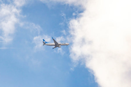 Madrid, Spain; January 14, 2026: Air Europa commercial passenger jet climbing shortly after takeoff, flying through clouds and blue sky. Aviation departure, air travel and transportation conceptのeditorial素材