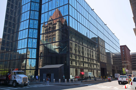 Trinity Church reflecting on John Hancock tower in Copley Square Boston