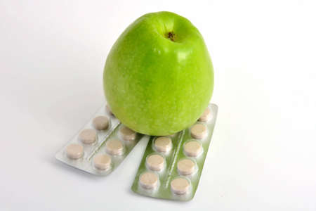 Green apple crushed pills on white backgroundの写真素材