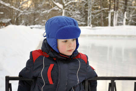 Sad little boy at the ice rinkの写真素材