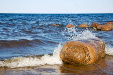 Large stone in the spray of waves. Lake Ladogaの写真素材
