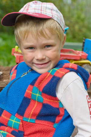 Five year old boy playing in a sandbox