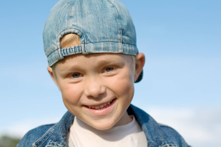 Five year old boy laughs  Against the blue skyの写真素材