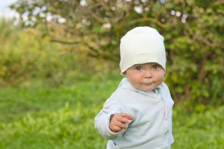 Cheerful baby for a walk in the garden の写真素材