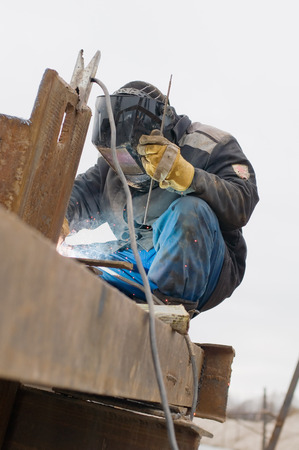 The welding mask welding beams. Manufacturing of metal constructions.の写真素材