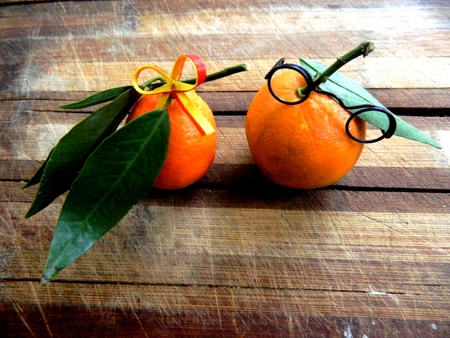 couple married ripe nectarine orange glasses and yellow nectarines with a bow with long green leaves lie on the brown wooden kitchen board love and understanding, happiness, on a horizontal surface in front of visasの写真素材