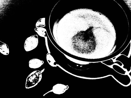 A small incomplete cup of tea and scattered briar berries near a cup on the boardの写真素材