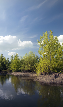 Outdoor nature. Daytime summer landscape with river and blue sky.の写真素材