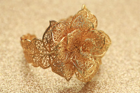 gold rose flower ring on glitter background