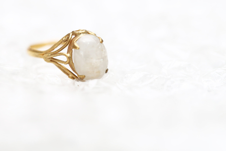 Opal white gem stone on gold ringの写真素材
