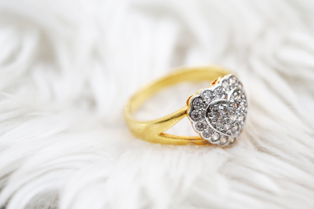 Diamond heart symbol on gold ringの写真素材