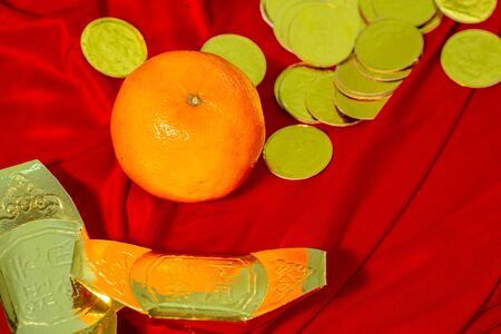 Oranges and gold on red fabric, Chinese New Yearの写真素材