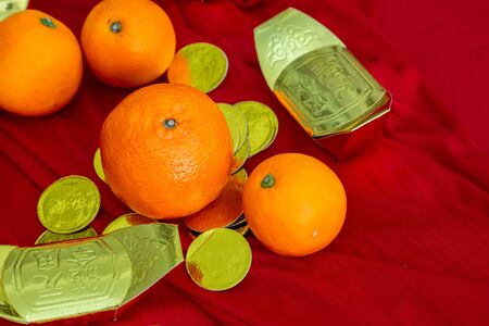 Oranges and gold on red fabric, Chinese New Yearの写真素材