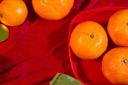 Oranges and gold on red fabric, Chinese New Yearの写真素材