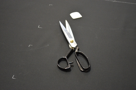 cutting table, lined fabric and scissorsの写真素材