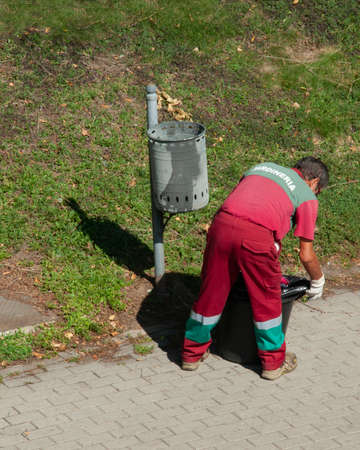 Street cleaner collecting garbage bags from the trash bin outdoors, top viewの写真素材