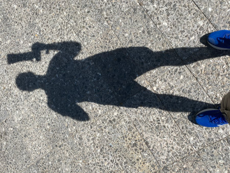 Shadow of photographer on the ground with telescopic lens , backgroundの写真素材