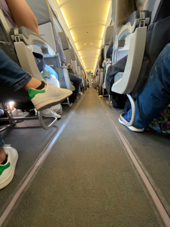 Interior of airplane with passengers on seats while flying. Travel concept,selective focusの写真素材
