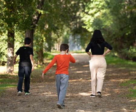 Hispanic mother with two children walking in a forest. Adventure conceptの写真素材